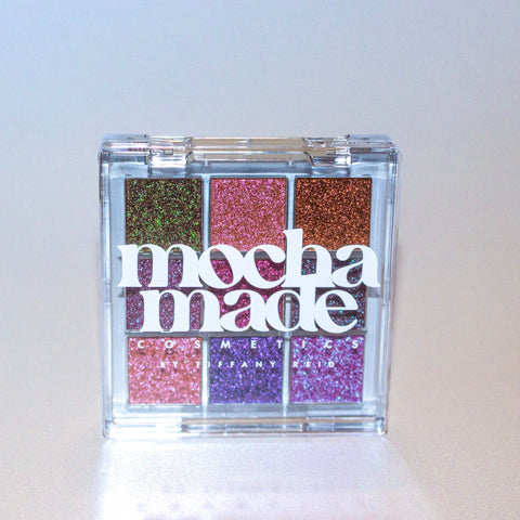 A six color fall equinox themed multi chrome eyeshadow highlighting palette based on the color spectrums of the Libra zodiac sign includes pinks purples blues green and bronze rusty orange