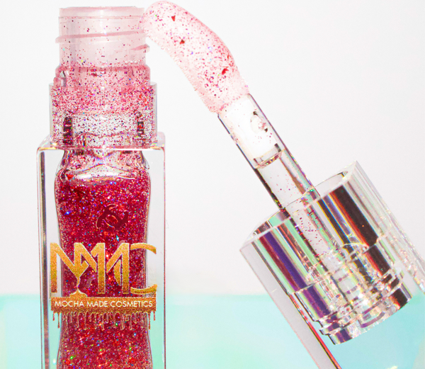Ruby is a clear hydrating lip gloss with sparkling red and pink glitter. 