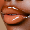  a high shine caramel nude lip gloss with warm beige undertone creamy slightly opaque finish with fine gold shimmer