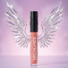 Mocha Make lip gloss in a clear tube showing a peachy pink color, topped with a black cap, set against a sparkling purple background with a stylized clear wing graphic behind it.