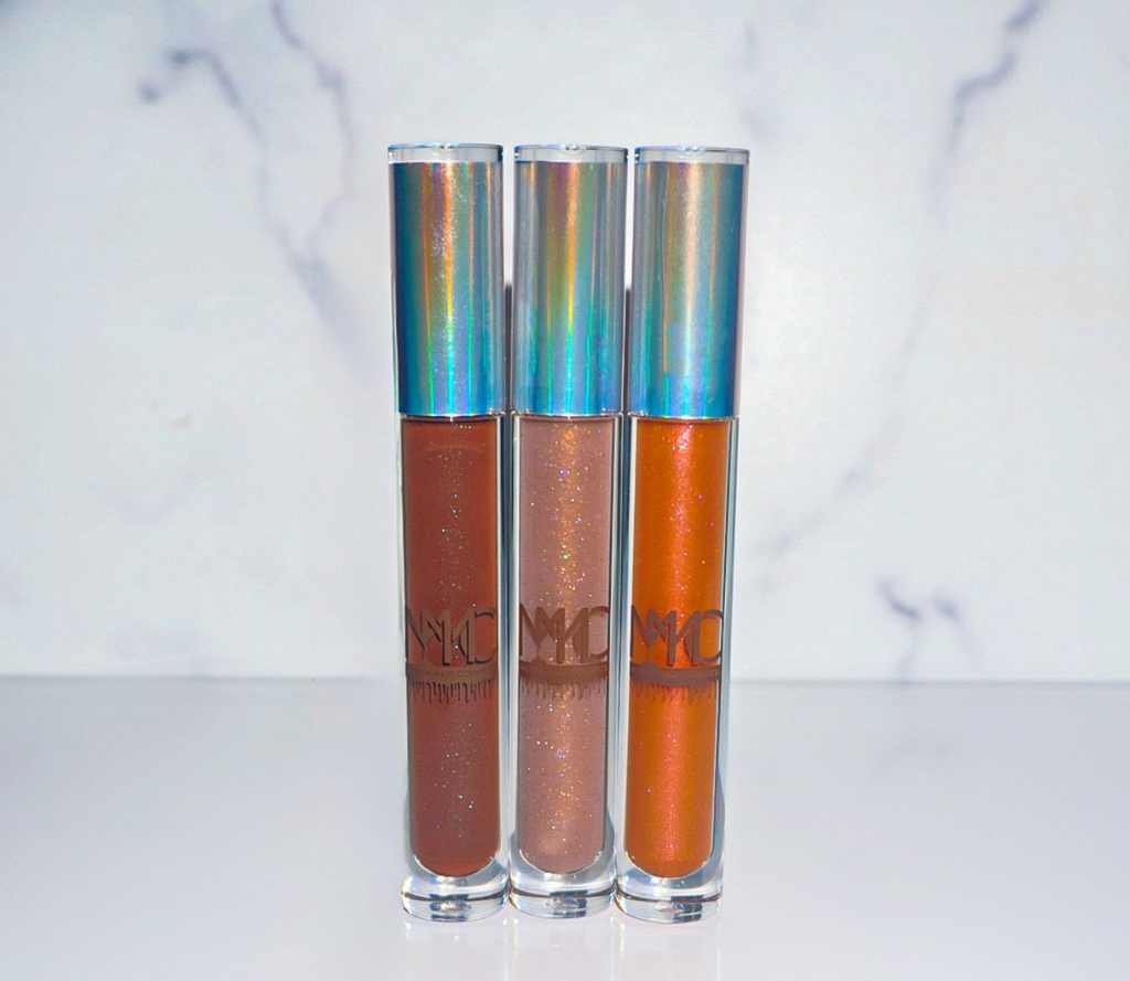 chocolate brown with blue glimmering sparkles throughout the gloss give the dark brown color the pop on the lips Coco Honey Dew is a sheer nude lipgloss with flecks of purple and gold glitter Leo AF is a shimmering bronze glittery fiery reddish orange gloss