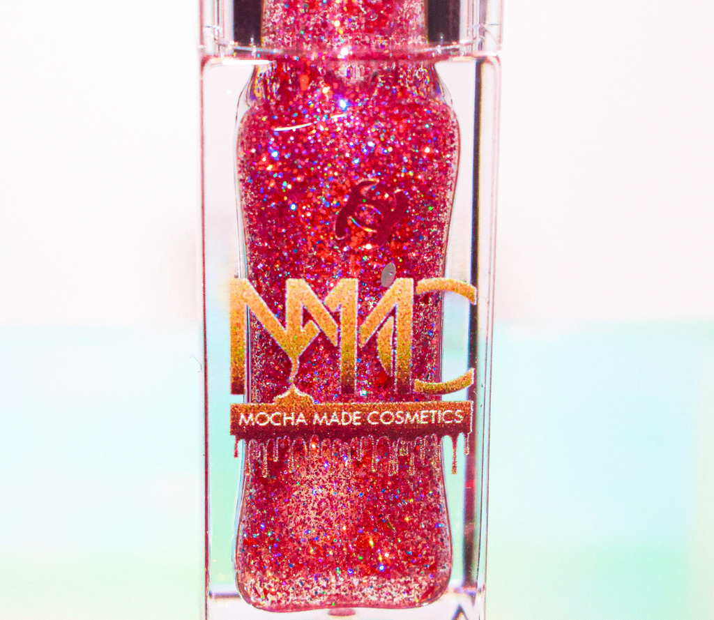 Ruby is a clear hydrating lip gloss with sparkling red and pink glitter. 